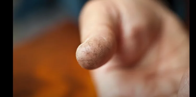 When you place your finger on the button, it may scan your fingerprint as well as the position of your pores